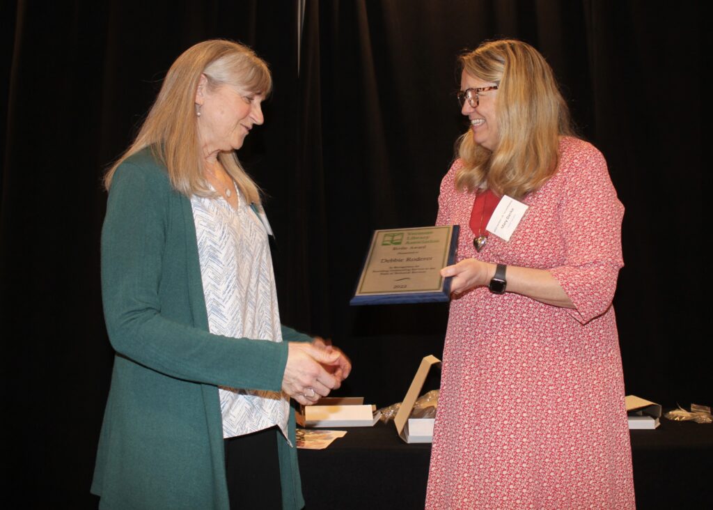 Debbie Roderer, assistant director at Dorothy Alling Memorial Library, receiving the Birdie Award.