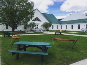 Image of outside of Vermont Law School Library with picnic table and hammocks