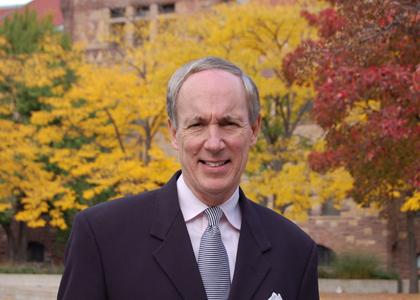 headshot of sullivan standing outside in front of the autumnal trees