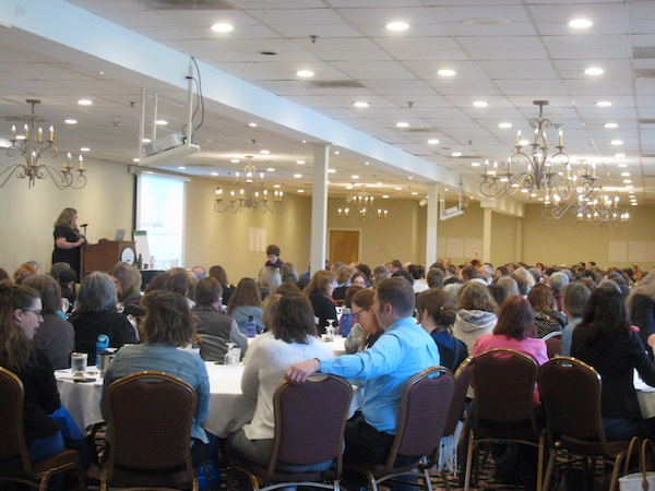 image of conference presenter and large room full of librarians
